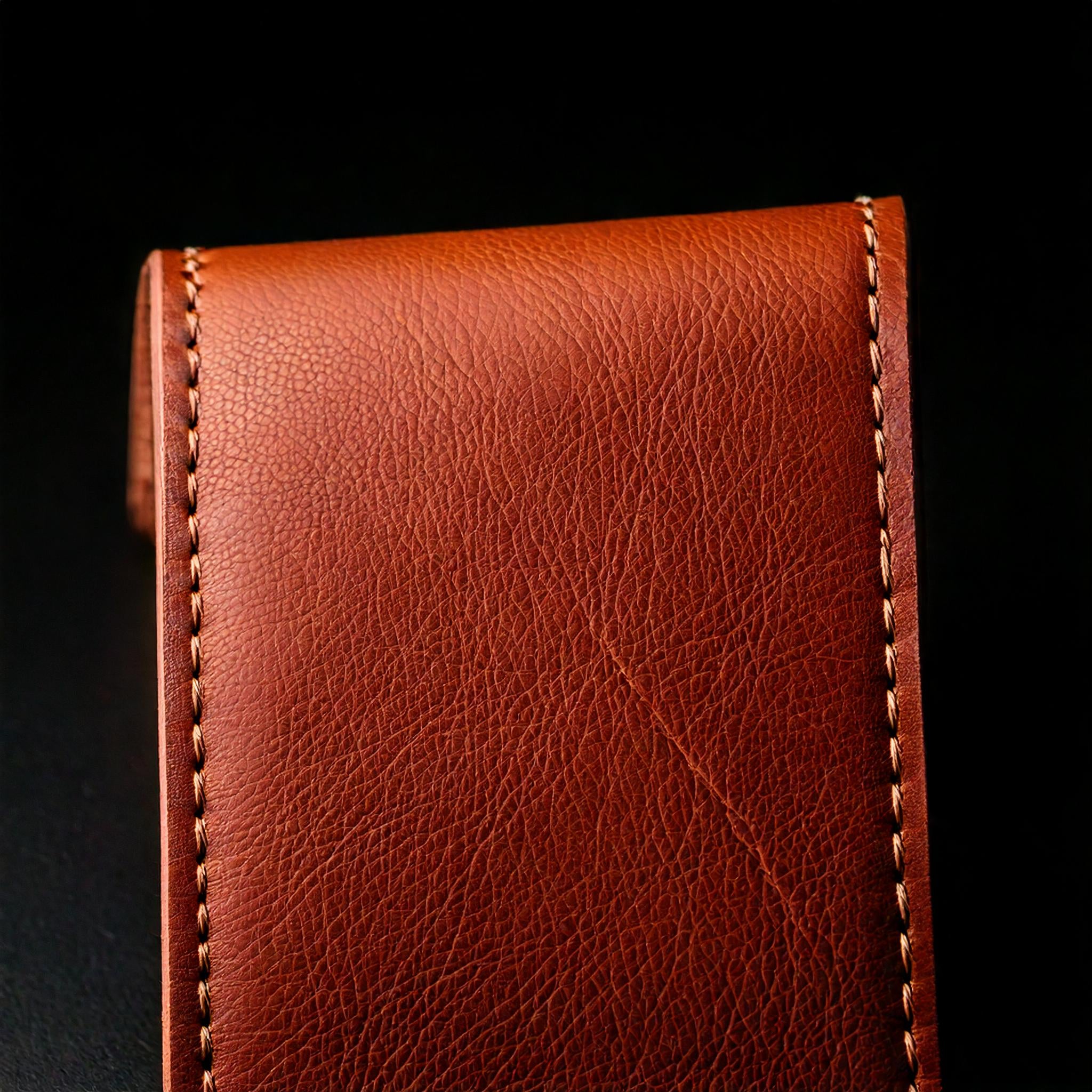 Firefly_Close_up_professional_picture_of_brown_top-grain_leather_with_stitches_isolated_over_black_b.jpg