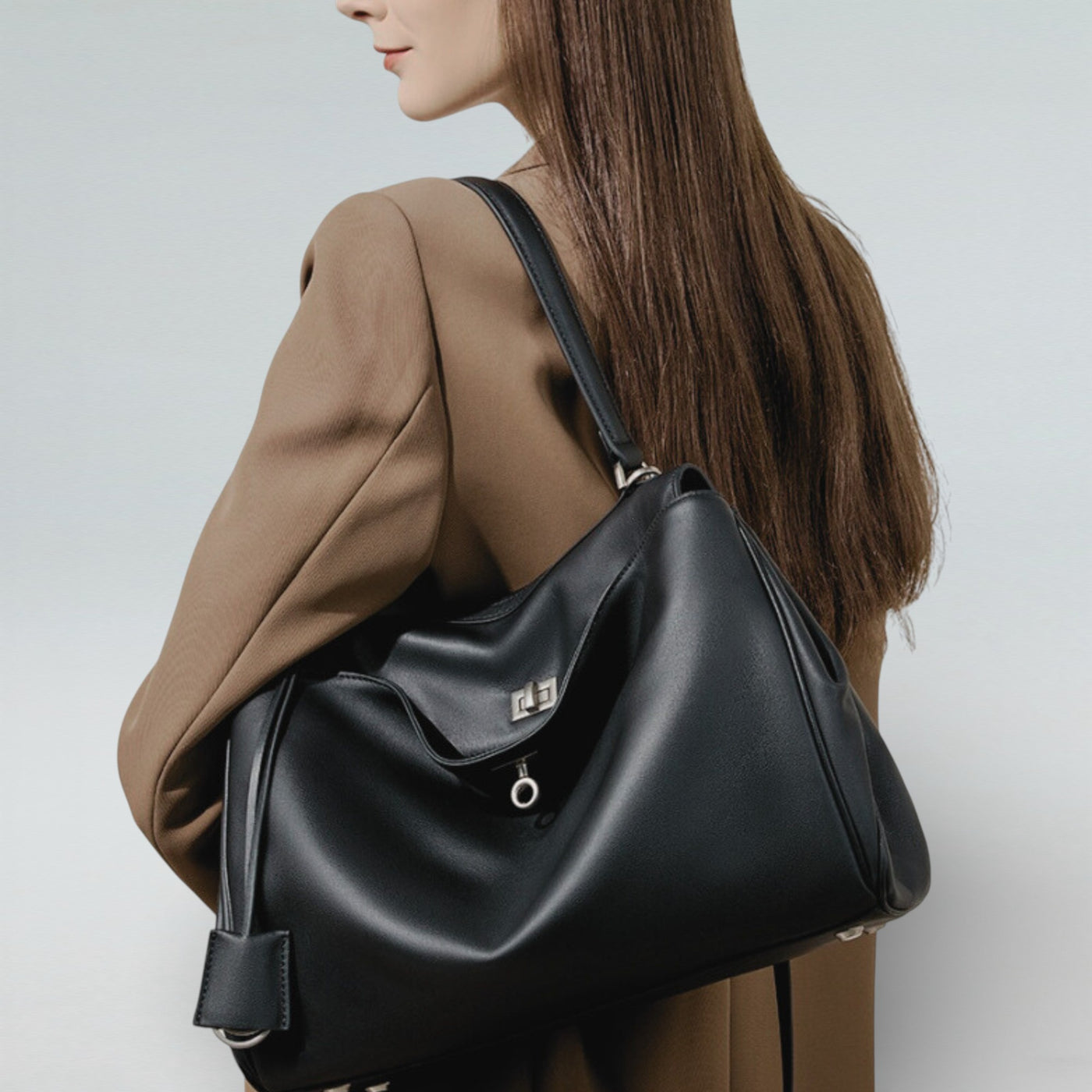 Model carrying Bagulia Louve Locket Tote Bag in Black Leather — Back View