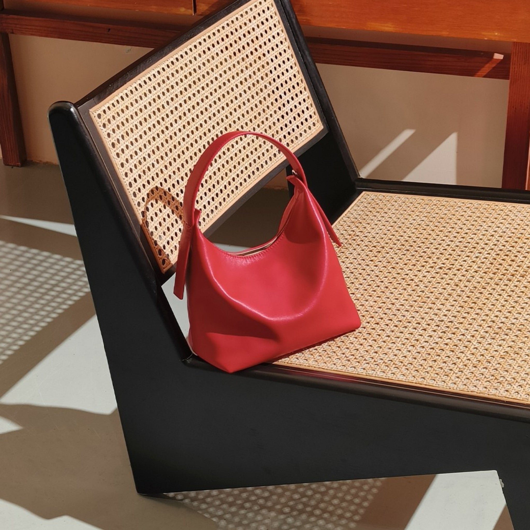 Slavia-Smooth-Top-Grain-Handbag-Red-Bagulia-On-A-Chair.jpg