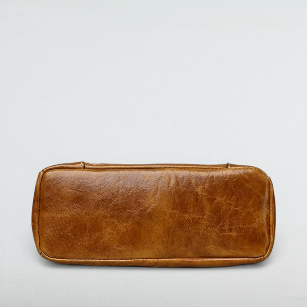 Bottom view of the Bagulia Petra Glossy Leather Tote Bag in Caramel showing base and feet