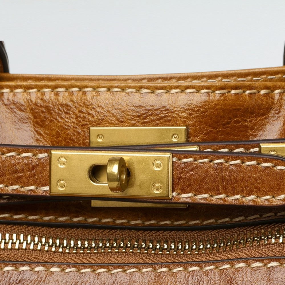 Close-up of the full-grain glossy leather texture on the Bagulia Petra Tote Bag in Caramel