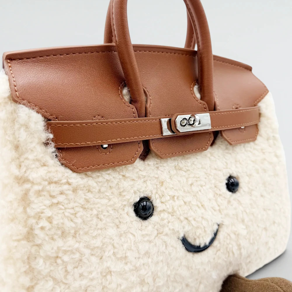 Close-up of the silver turn lock and brown leather flap on the Bagulia Birky Cream teddy plush bag