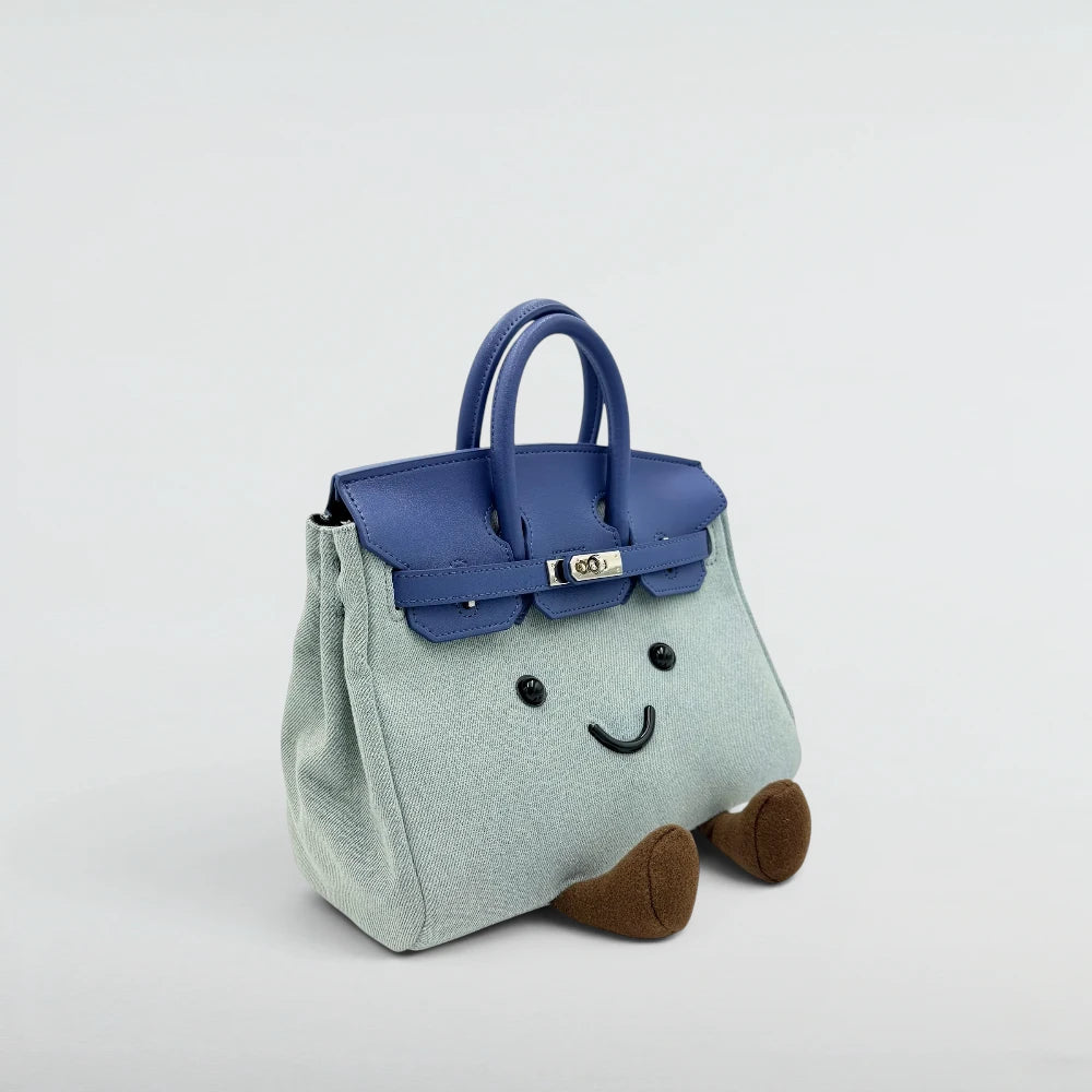 Bagulia Birky Denim handbag with blue leather flap and silver lock, three-quarter angle view