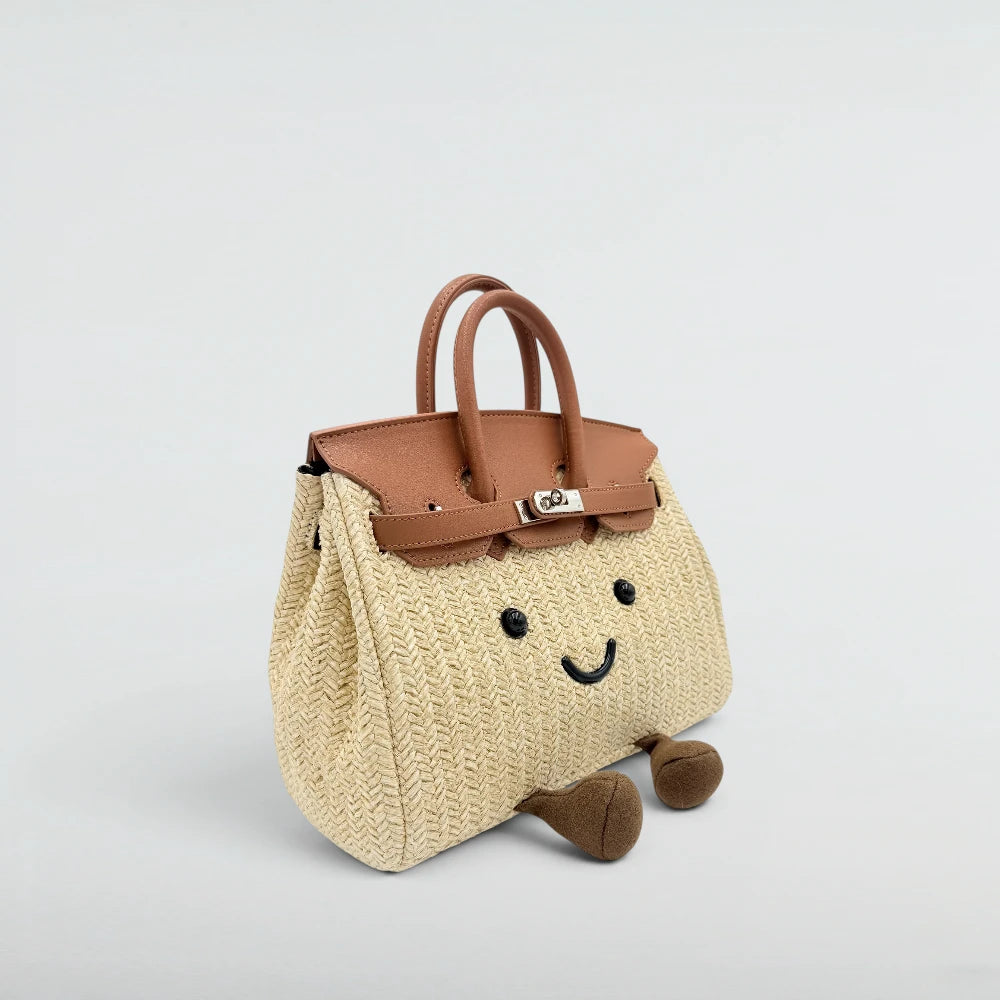 Bagulia Birky woven straw handbag with tan leather flap, three-quarter angle view