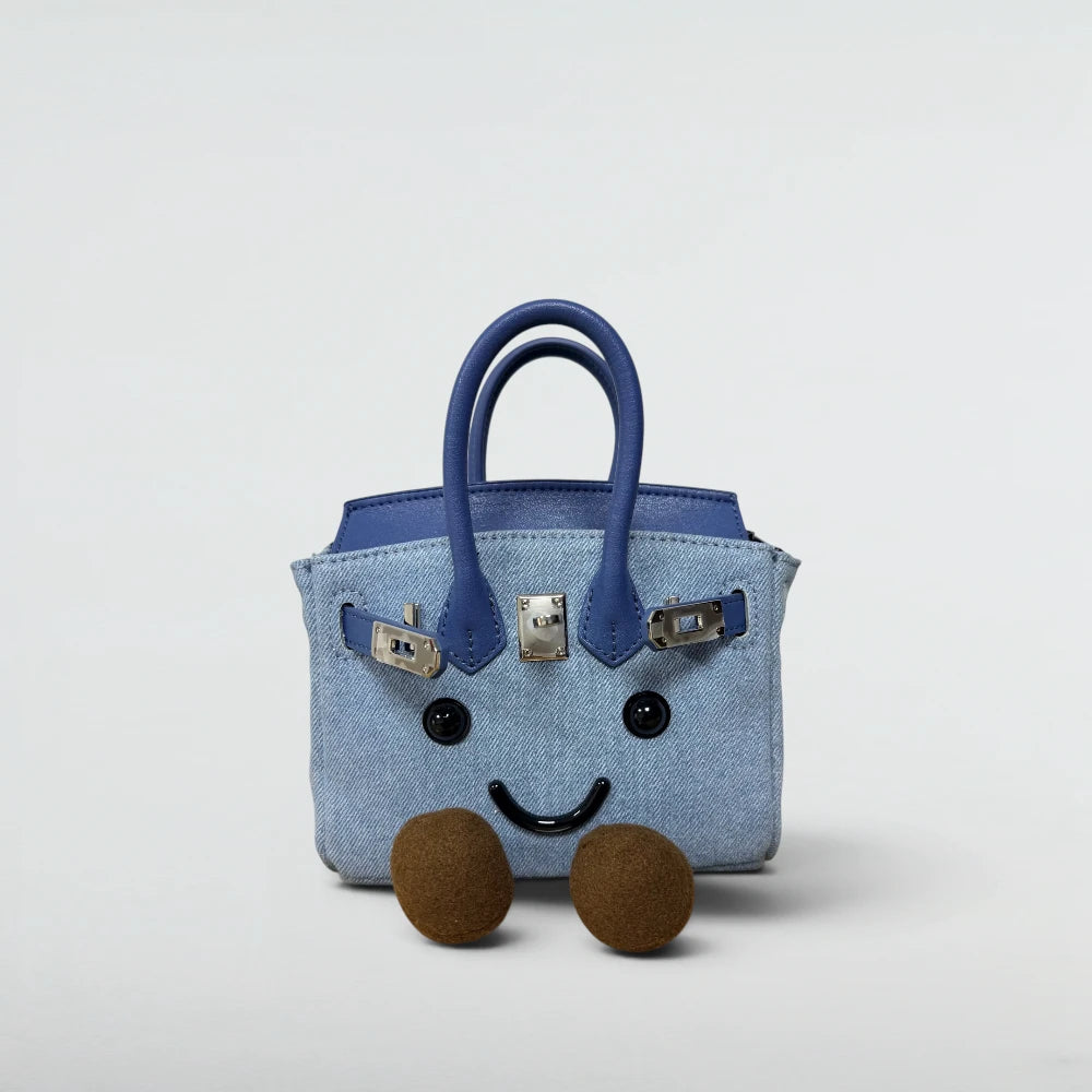 Bagulia Birky 18cm Denim mini bag with navy handles and smiley face, front view