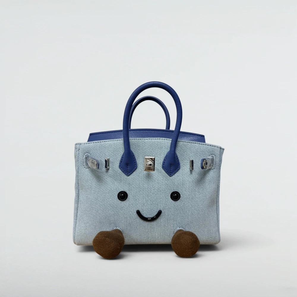 Bagulia Birky 18cm mini denim Birkin-style bag with navy leather handles and smiley face, front view