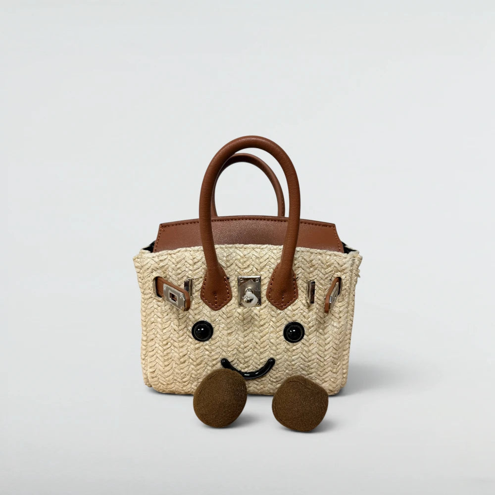 Bagulia Birky 18cm mini woven straw Birkin-style bag in natural raffia with smiley face, front view