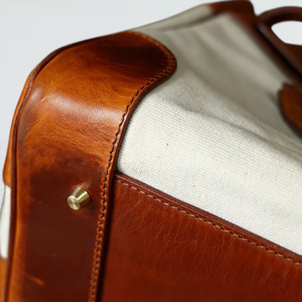 Bagulia Damascus travel bag, cream canvas, rolled leather handle and top corner detail