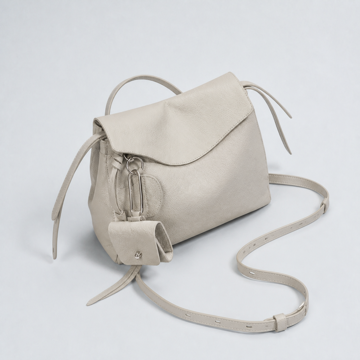 Leyla pearl grey pebbled leather shoulder bag, closed top-down studio view
