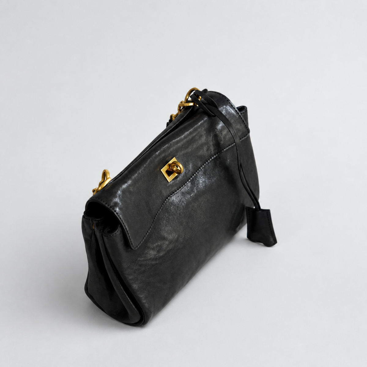 Bagulia Louve Locket Patina Bag in Black vegetable-tanned leather, side view