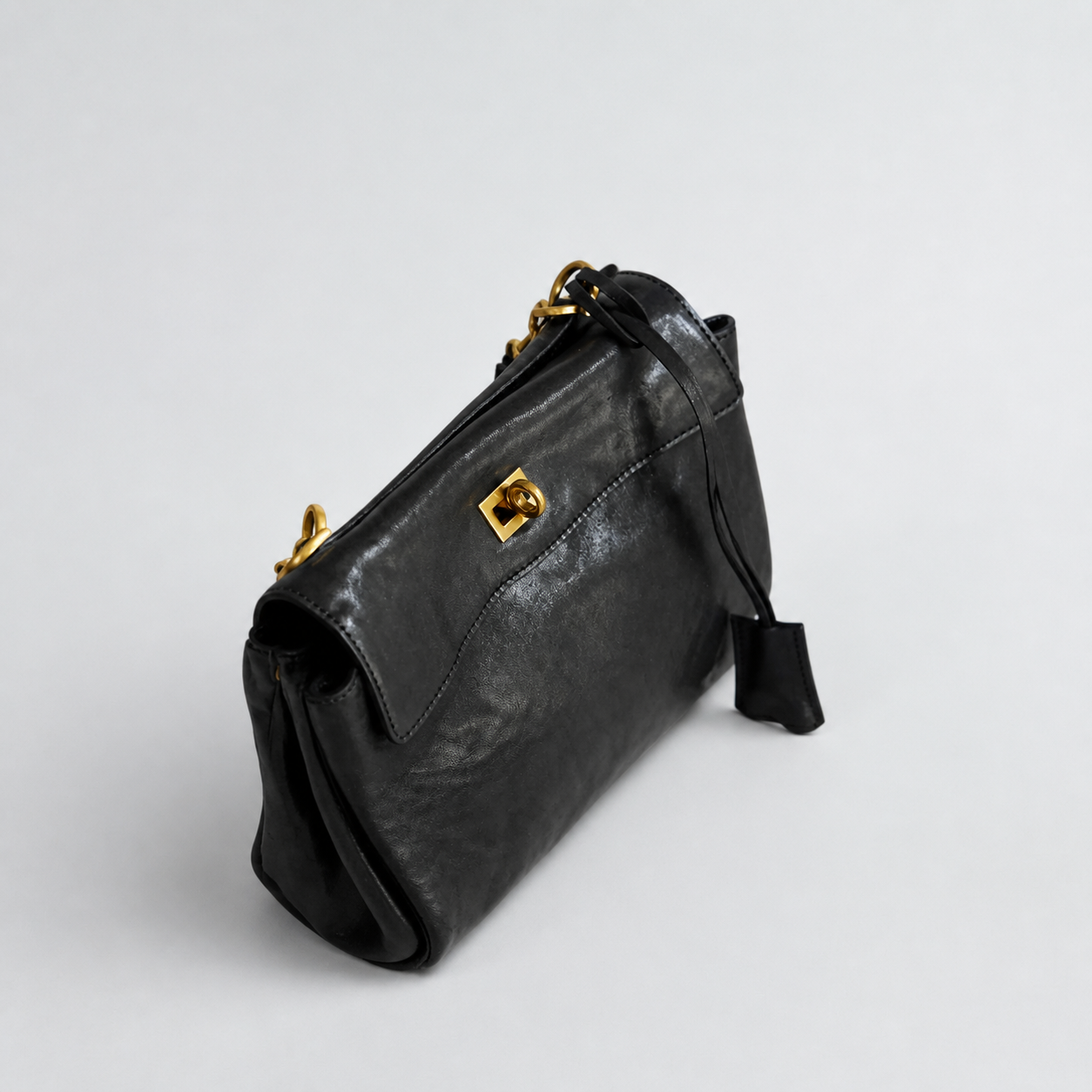 Bagulia Louve Locket Patina Bag in Black vegetable-tanned leather, side view