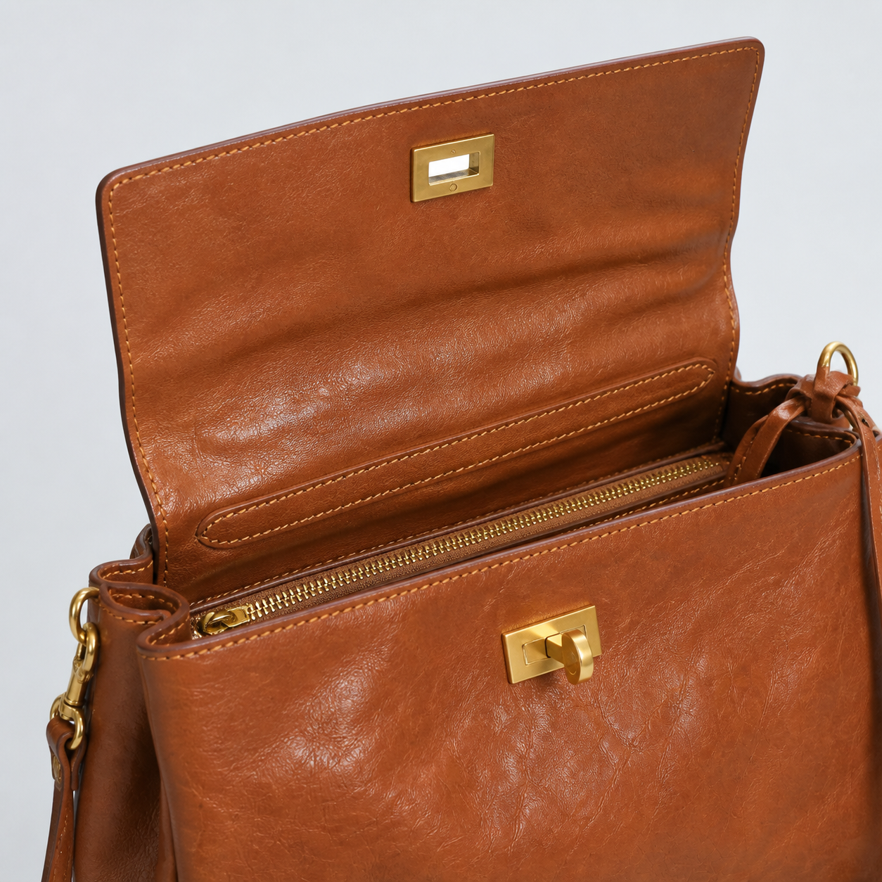 Bagulia Louve Locket Patina Bag in Cognac Brown with leather-lined flap and inner zipped divider