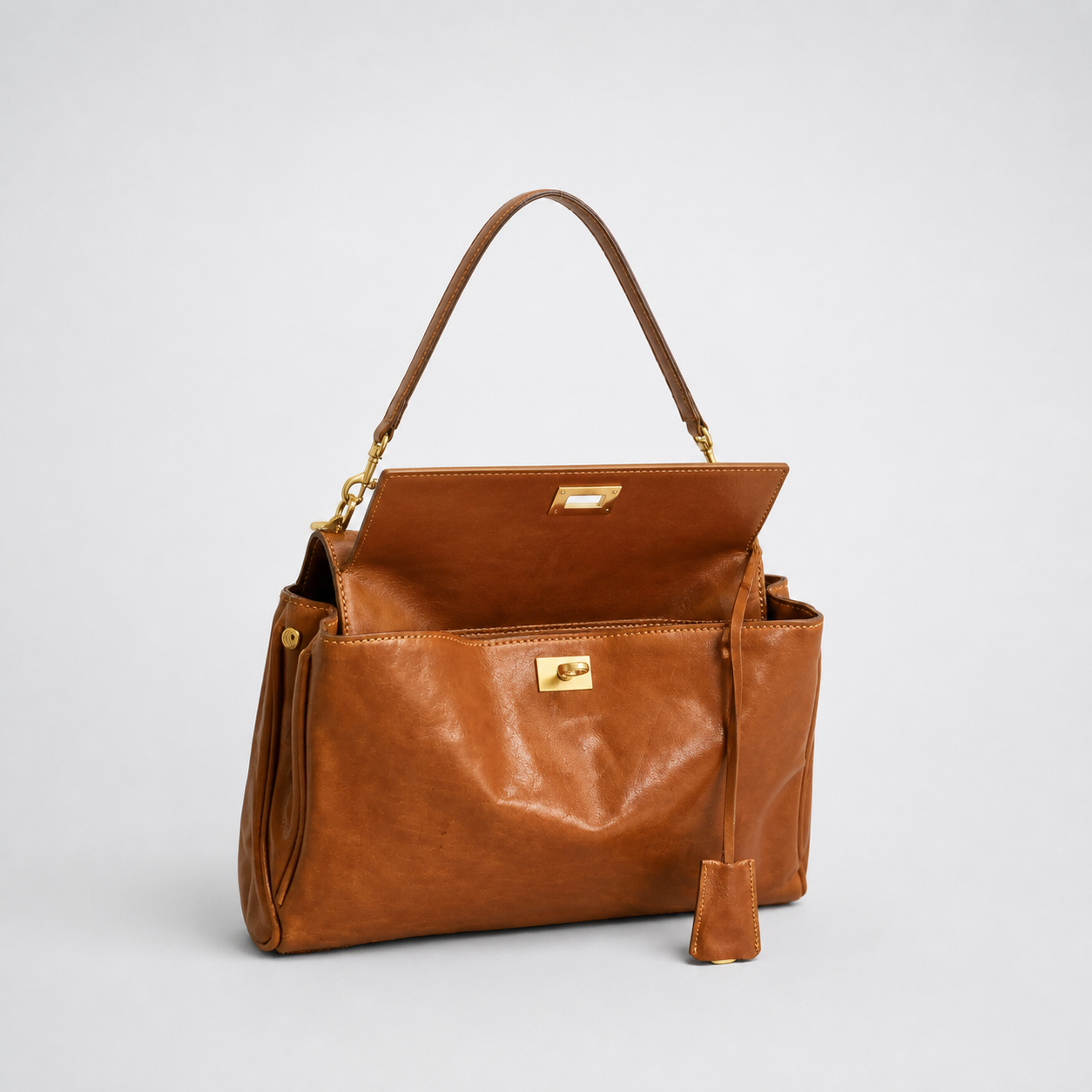 Bagulia Louve Locket Patina Bag in Cognac Brown with turn-lock flap open