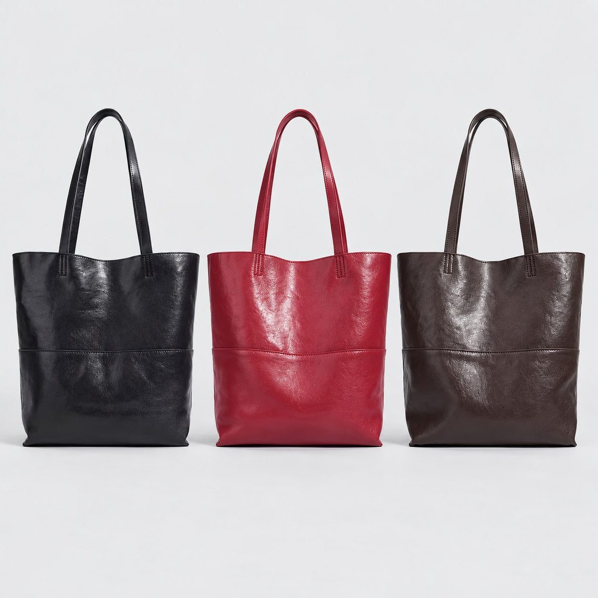 Bagulia Marielle totes in Black, Cherry Red and Dark Brown shown together.