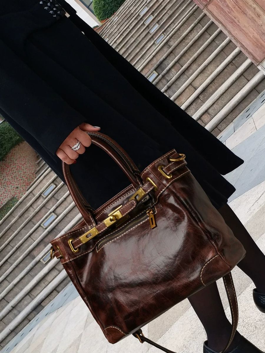 Woman carrying the Bagulia Petra Glossy Leather Tote Bag in Coffee on her shoulder