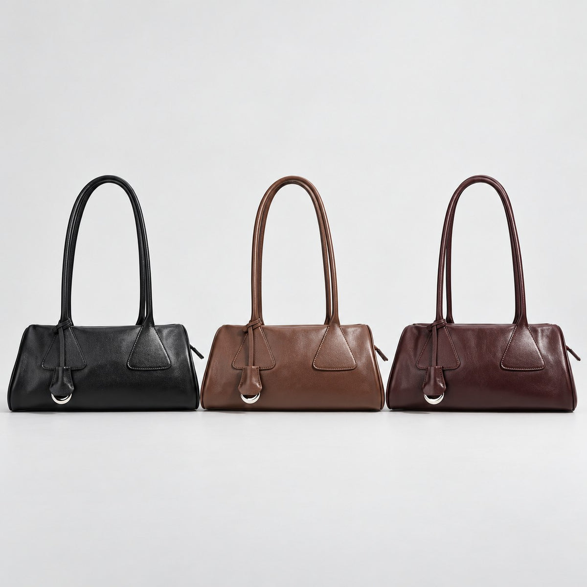 Bagulia Vera shoulder bags in Black, Brown and Oxblood arranged together.