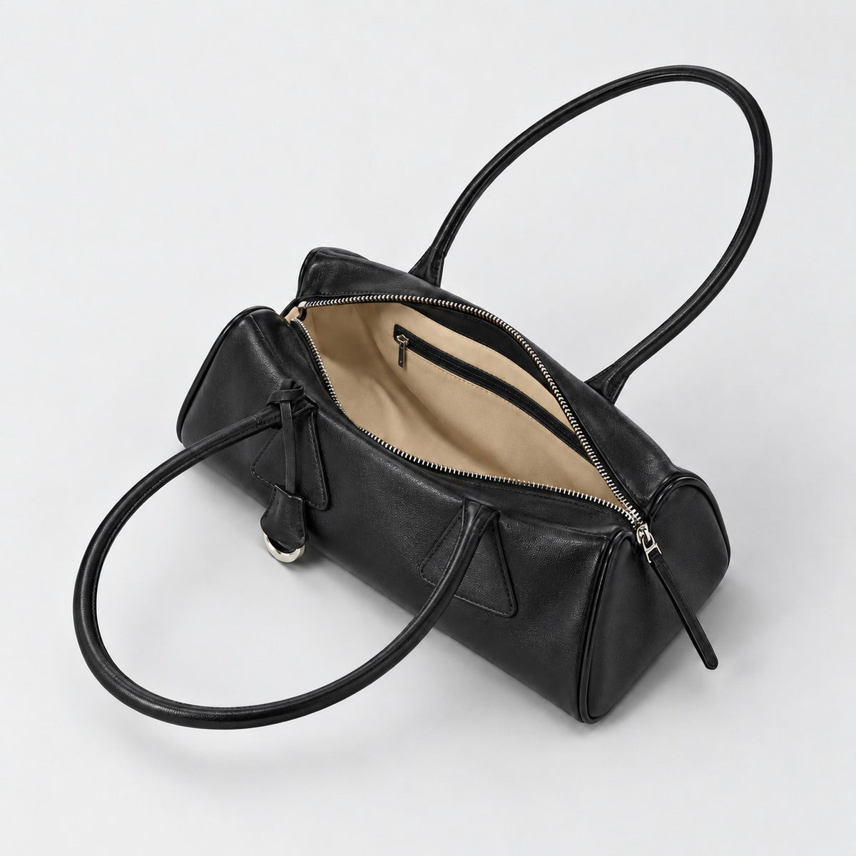 Open black Bagulia Vera shoulder bag showing its beige lining and internal zipped pocket.
