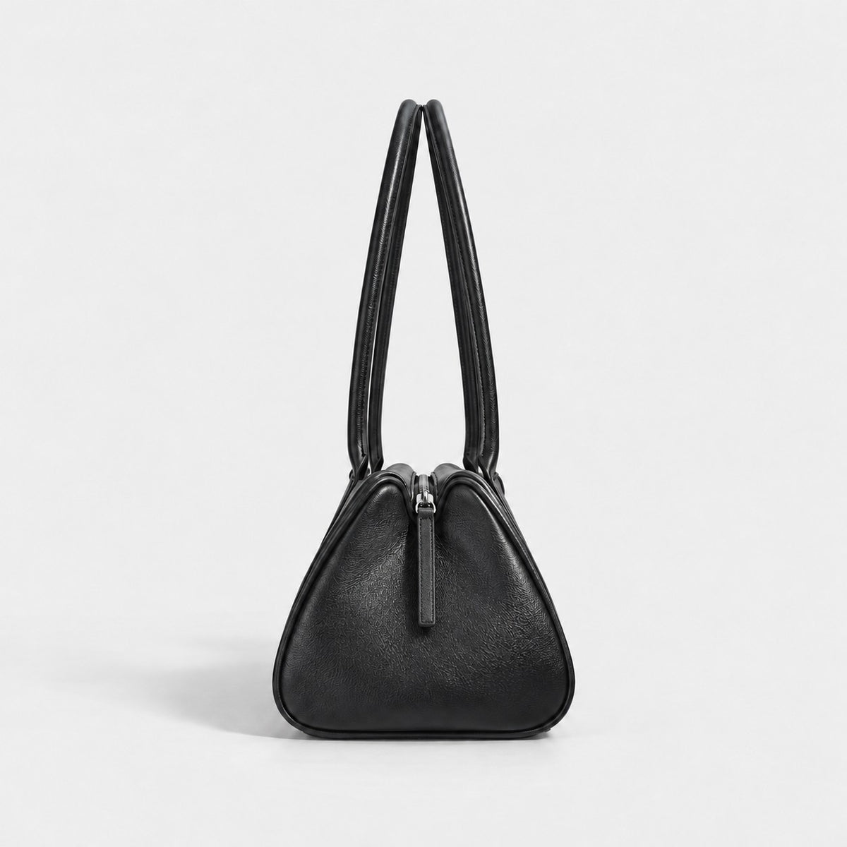 Bagulia Vera shoulder bag in black shown in side view.