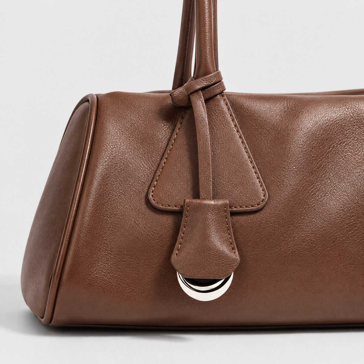 Bagulia Vera shoulder bag in brown shown in handle detail view.