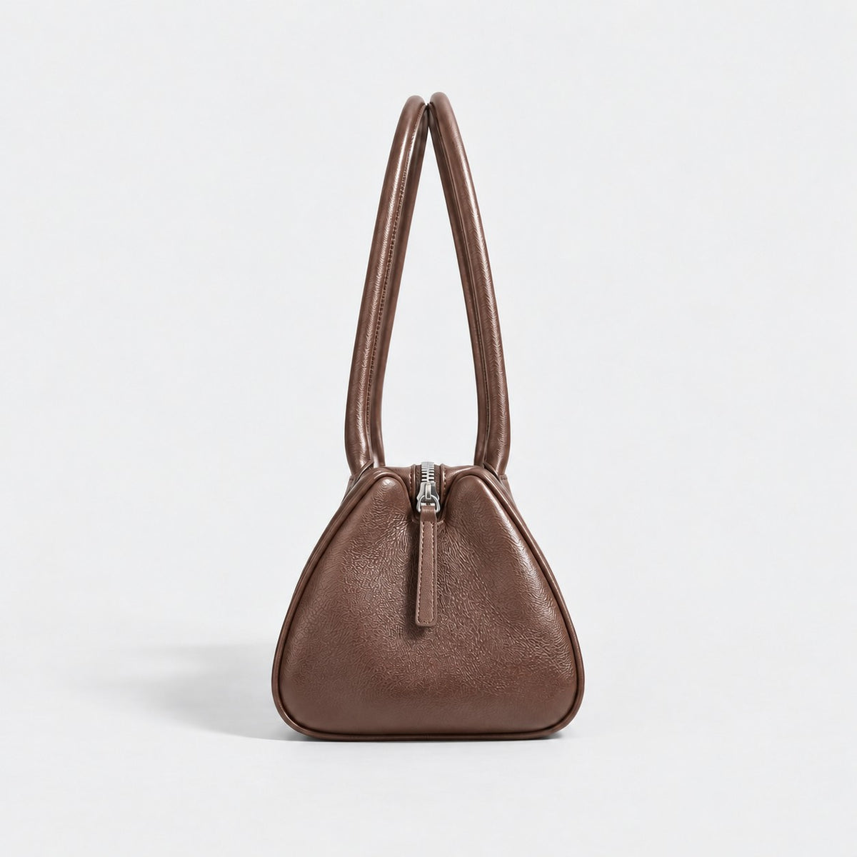 Bagulia Vera shoulder bag in brown shown in side view.