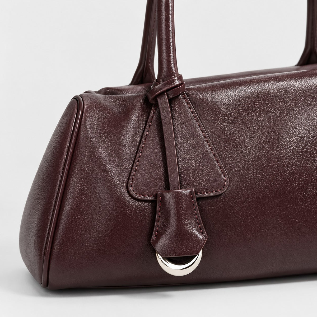 Bagulia Vera shoulder bag in Oxblood shown in handle detail view.